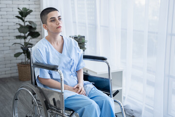 Obraz premium Patient Caucasian woman sitting in wheel chair in hospital ward and front of window