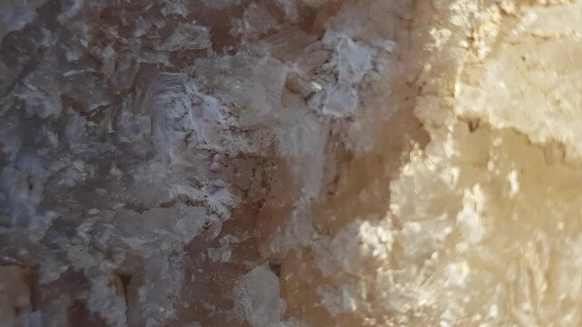 A detailed close-up of raw barite showcases its unique formations and textures, placed in a genuine setting to enhance the mineral's natural beauty and highlight its glassy luster.
