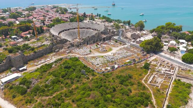 Side, Manavgat, Turkey. Ancient Roman amphitheater, Monumental Gates of Side, Side Museum in Roman baths, Temple of Tyche in ancient city on summer day. Aerial View
