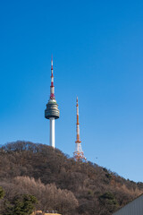 Fototapeta premium N Seoul Tower with autumn landscape. It is also known as Namsan Tower or Seoul Tower, the landmark which is a communication and observation tower located on Nam Mountain in central Seoul, South Korea
