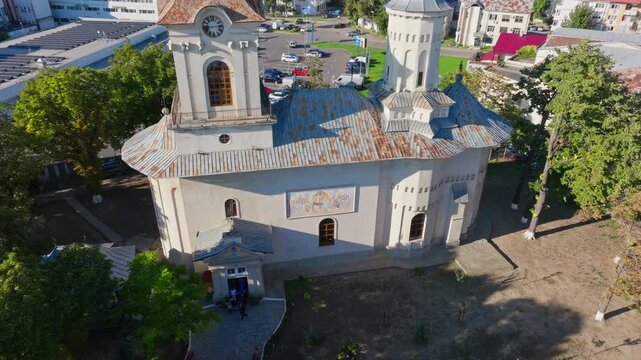 Aerial shot of old Romanian church, Christian orthodox landmark of Botosani - drone orbit view