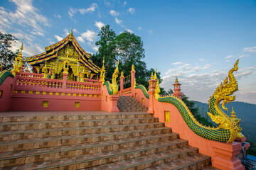 Fototapeta premium Landmark Sunrise with sky at Wat Phra That Doi Phra Chan on the top hill of Doi Phra Chan mountain in Mae Tha, Lampang province, Thailand