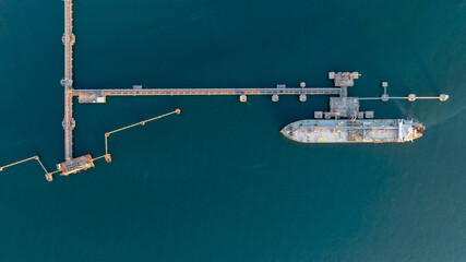 Aerial view oil and gas ship tanker vessel loading unloading in oil terminal station refinery, Global business import export logistic transport sea freight cargo tanker, Oil gas tanker ship at port. © Kalyakan