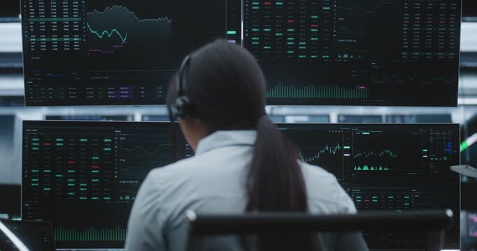 Asian Female Executive Manages Global Portfolios in Huge Digital Stock Exchange. Concept of Market Leadership, Professional Success and Innovative Technology in High Stakes Financial Services.