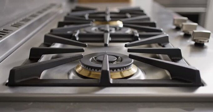 Close-up of a modern gas stove with multiple burners, showcasing sleek design and functionality