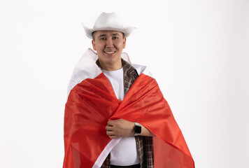 Happy man holding Canada flag behind his back in studio