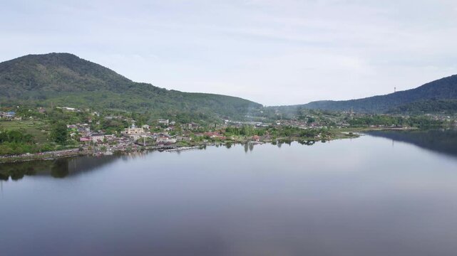 Pura Ulun Danu Bratan Sacred Balinese Temple on the Shore of Lake Beratan Surrounded by Mountain Landscape and Traditional Village &ndash; Aerial Drone View
