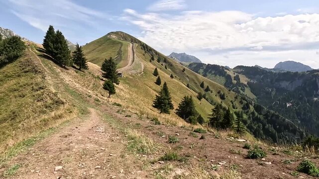 Hiking Trail on the Grande Travers&eacute;e des Alpes GR5 with Mountain Ridges and Alpine Meadows Under Blue Sky &ndash; Hyperlapse