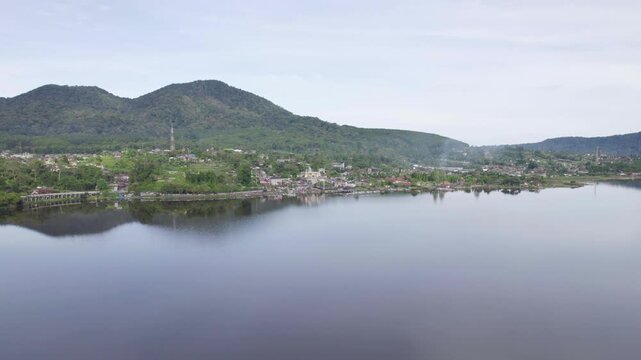 Flying Over Sacred Lake Beratan At Daytime In Bedugul, Bali, Indonesia. - aerial shot