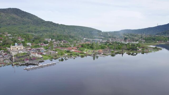 Bedugul Pier And Pura Ulun Danu Beratan Temple On The Shores Of Lake Beratan In Bali, Indonesia. - aerial shot
