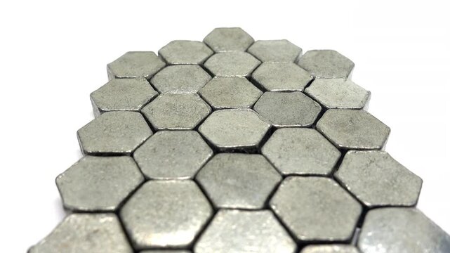 Moving low past an arrangement of metal hexagons.