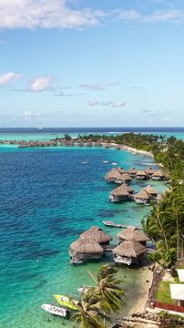 Vertical Drone Shot of Bora Bora Island, French Polynesia, Matira Beach and Luxury Tropical Resort With Villas Over Water