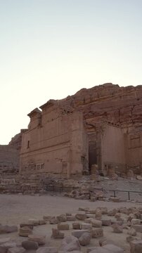 Vertical shot of the historic Qasr alBint temple ruins in Petra, Jordan. Showcasing ancient Nabataean architecture and sandstone cliffs for travel and history documentaries.