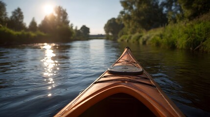Fototapeta premium Kayaking down a sunlit river with lush green banks seen from the perspective of the kayak
