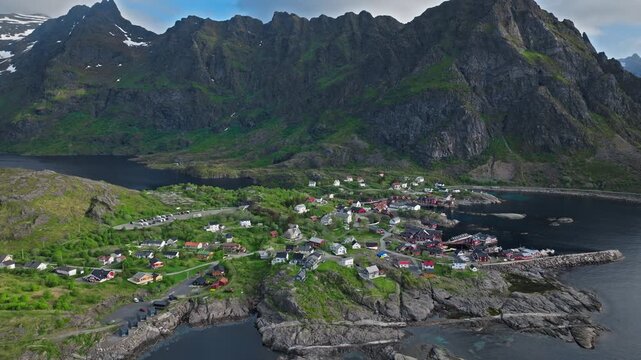 Aerial drone view of &Aring; harbor and Norwegian Fishing Village Museum in Lofoten, Norway. Historic norwegian village with colorful houses beside calm northern waters.