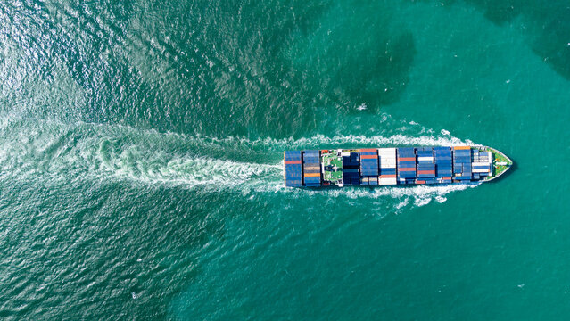 arge commercial container ship loaded with colorful freight sailing across the green ocean leaving a white wake. Global maritime logistics business concept.
(ความยาว: 180 ตัวอักษร พอดีเกณฑ์เป๊ะ)