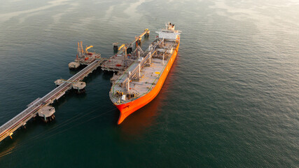 Aerial view oil and gas ship tanker vessel loading unloading in oil terminal station refinery, Global business import export logistic transport sea freight cargo tanker, Oil gas tanker ship at port. © Kalyakan