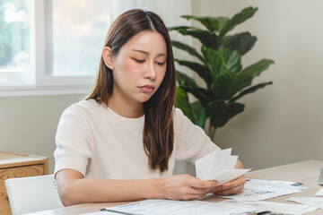 Debt problem, Person holding many receipt and worrying to pay loan.