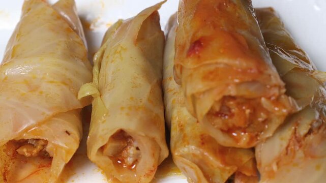 Cook puts cabbage rolls on a plate 4k video