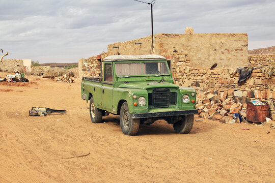 Ouadane, Mauritania - 10 Jan 2022: The vintage car on the street of the local village close old city Ouadane in Sahara desert, Mauritania