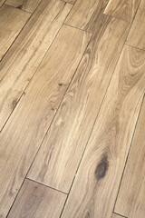Close up view of natural light brown hardwood floor planks with distinct grain pattern