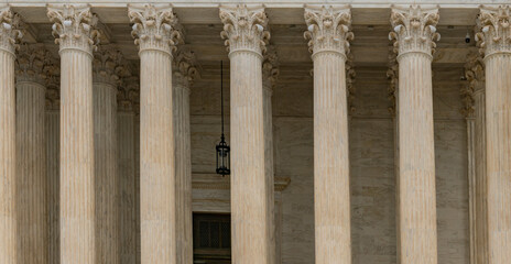 Fototapeta premium Columns fluted marble background texture. Columns repetition symmetry layout. Columns architectural pattern detail. Columns classical stone texture.