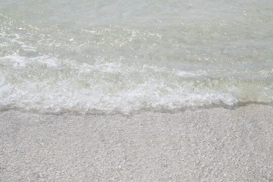 Transparent water in sea for summer background. Transparent water on sand for clean texture. Transparent water in surf for serene mood. Transparent water on shoreline for coastal calm.