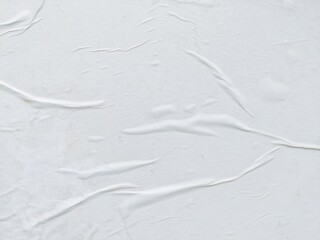 Obraz premium Blank abstract background of white crumpled paper. Creased poster texture with wavy surface. Wrinkled white paper background detail.