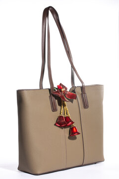 Beige women's leather bag on a white background