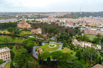 View of green gardens and historic buildings in Rome on a cloudy day
