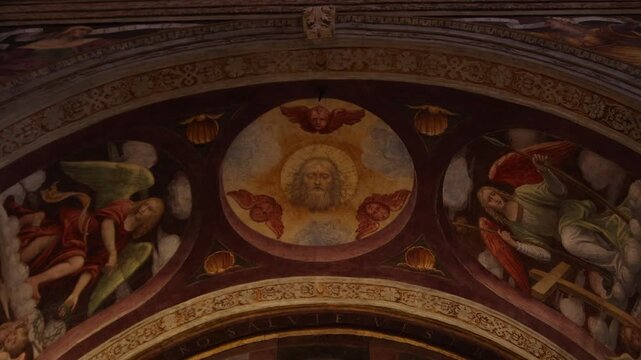 vibrant historic frescoes depicting biblical scenes on the ornate vaulted ceiling of a Milanese cathedral