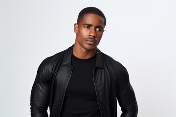 Obraz premium Young black man posing with a serious expression, wearing a black leather jacket