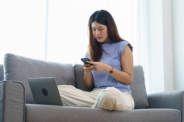 Fototapeta premium Happy beautiful Asian Woman. Business woman working from home with laptop Financial Home work space concept.