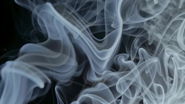 Dry ice smoke floating on black floor concept. Abstract swirling white smoke patterns on dark background for artistic and mysterious effects