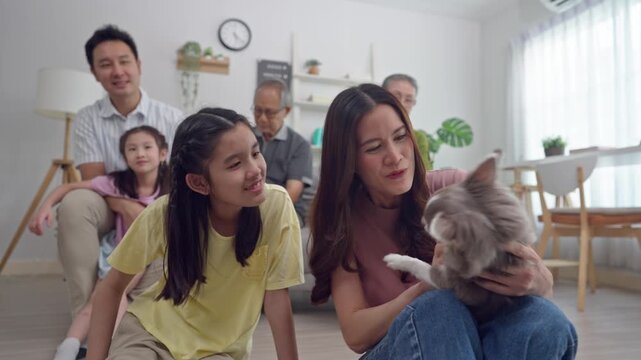 Asian family spending quality time together in living room at home. 