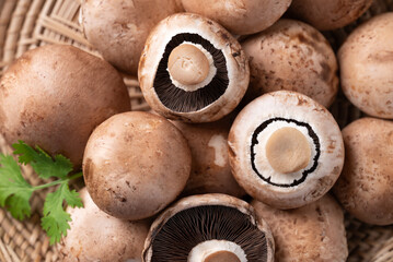 Fresh crimini mushroom or baby bella mushroom in a basket, Top view