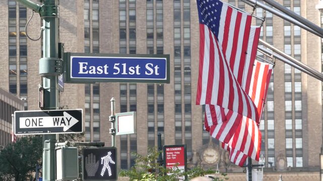New York City Park Avenue, street sign in Manhattan Midtown, United States. Urban road sign, traffic sign in NYC, USA. Building architecture near Grand Central. One way arrow and American flag.