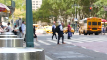 Sixth 6 avenue and 42nd street crossroad, Bryant park in Manhattan Midtown, New York City, United States of America. Defocused people pedestrians crossing on zebra near bank, yellow taxi car on road.