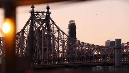 New York City Manhattan Midtown skyline from Queens, Queensboro bridge architecture, United States. Cityscape from rooftop in Long Island, Hunters Point. Light bulbs garland on roof, urban sunset.