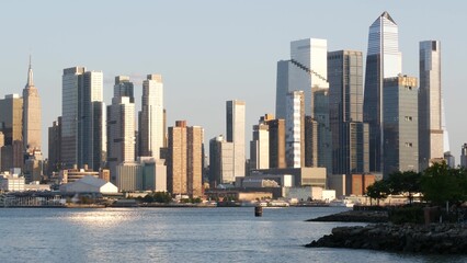 Obraz premium New York City Manhattan Midtown skyline, Hells kitchen and Hudson Yards from New Jersey, Weehawken Port Imperial, United States. Urban cityscape with skyscraper building, American architecture. River.