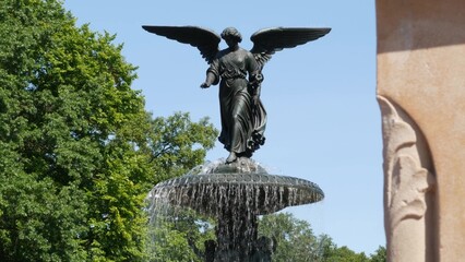 New York City Central Park Bethesda Fountain, angel statue by Bethesda Terrace on summer day,...