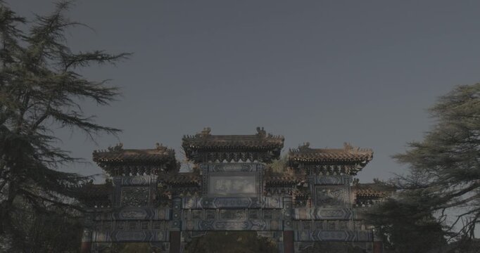 Beijing, China. Doves birds flying above Gate to ancient Lama Temple.