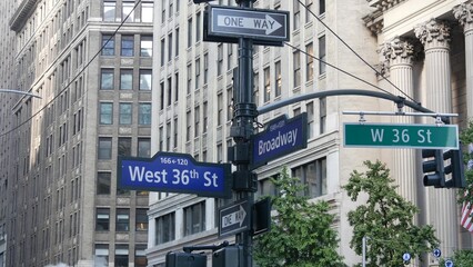 New York City Broadway and 36 street sign on Manhattan, United States. Urban road sign in american city. Traffic sign in Midtown of NYC. Building architecture, district near Herald Square. Hot steam. © Dogora Sun