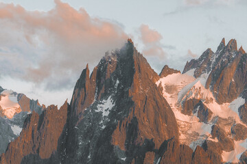 Naklejka premium Alpine mountain feflecting the colors of the sunset in the Alps