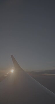 Vivid Sunrise Illuminating the Sky from Airplane Window