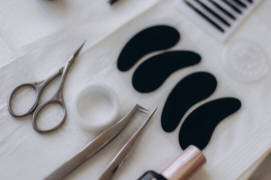 Eyelash extension tools and supplies on table