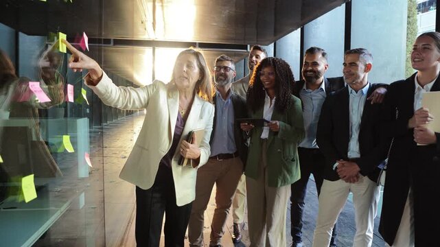 A diverse group of professionals engages in a collaborative brainstorming session, discussing innovative ideas and strategies to enhance productivity and teamwork in a dynamic environment.