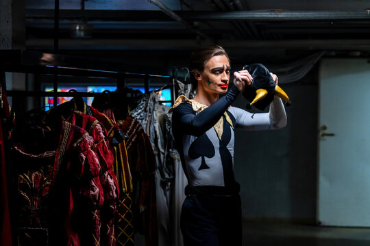 Man actor adjusts costume before performance. Theater backstage