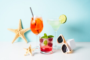 Margarita, Aperol Spritz and strawberry mojito at blue background.