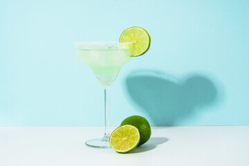 Margarita cocktail. Summer alcohol drink on blue background.